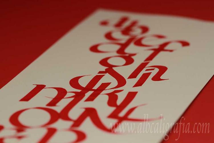 Alphabet in red in calligraphic style