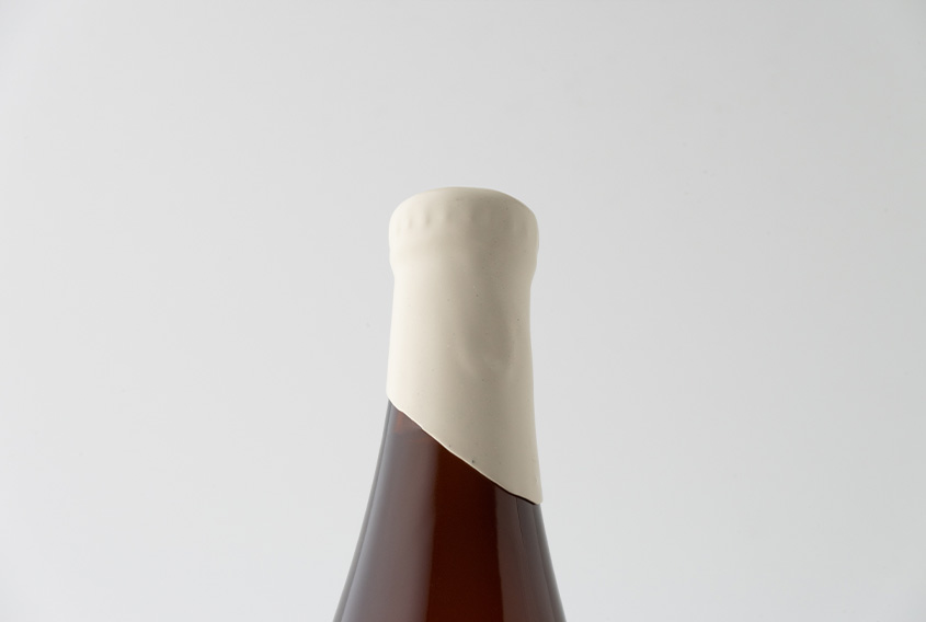 Beer bottle with Ivory sealing wax in the neck of the bottle leaving it in diagonal shape