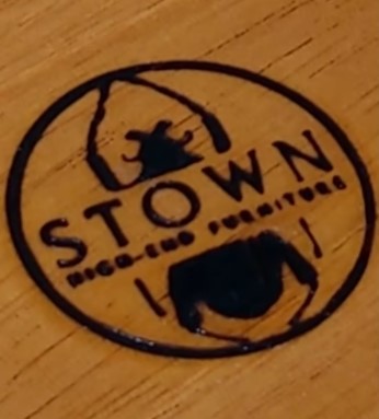 Heat engraved stamp with thermoengraving set on wood with the image of a beetle and the word STOWN
