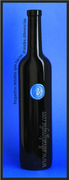 Black bottle with sealing wax medallion in royal blue color