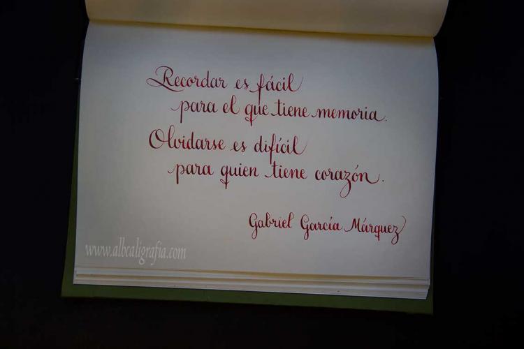 Calligraphic text in notebook: Remembering is easy for one who has memory. Forgetting is difficult for one who has heart. Gagriel García Márquez