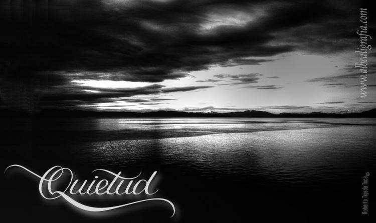 Landscape photography with mountains and sea in black and white and the word quietude