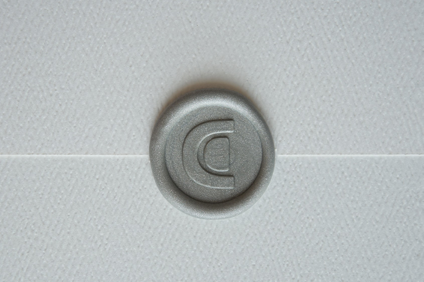 Sealed white envelope with CD logo in silver color