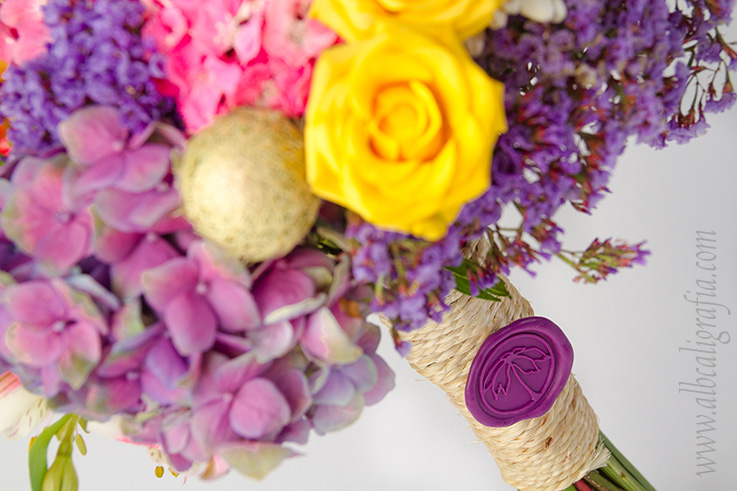 Bouquet of flowers tied and sealed with a purple sealing wax medallion