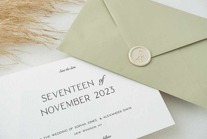 Sealed green envelope with SA initial design in ivory color, and with a wedding save the date card