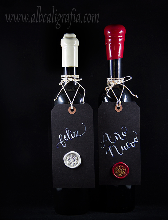  Wine bottles with tags hanging with text Happy New Year and sealing medallions on tag