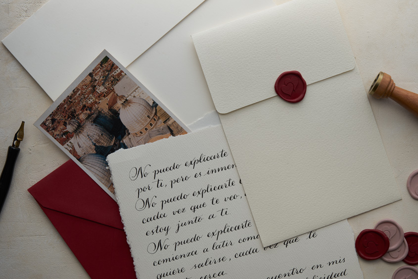 Letter written in calligraphy, with a sealing wax sticker in red color of hearts design, lavender and red sealing wax stickers and the seal