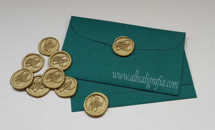 Green envelope with gold sealing wax medallions