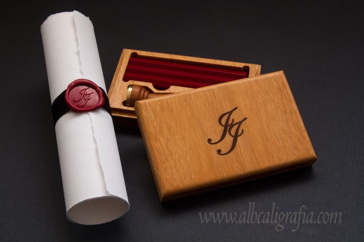 Wooden box with red sealing wax bars, engraved with initials JJ and parchment with black ribbon and red wax medallion