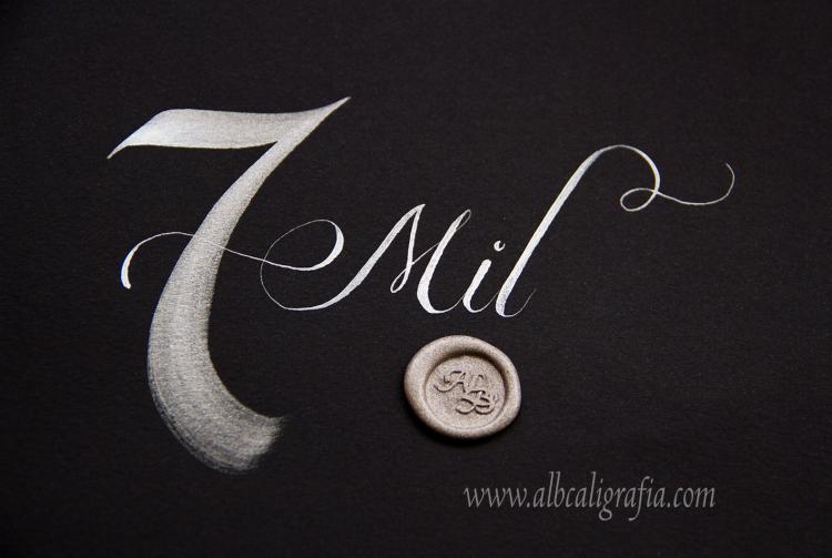 Black background with number 7 and Thousand word written in silver, silver sealing wax medallion