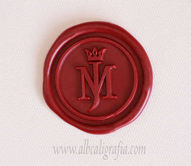 Red sealing wax sticker rwith initials MJ and crown