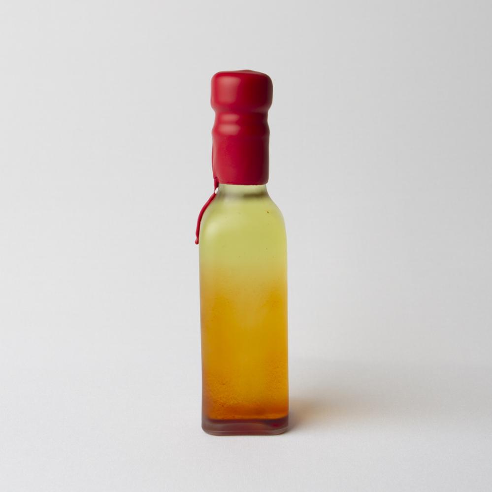 Small bottle in shades of orange and yellow, sealed with dripping red sealing wax