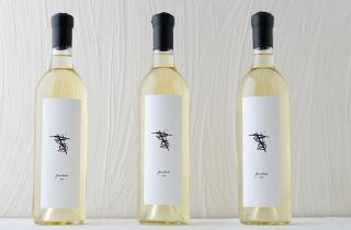 three Garabato wine bottles sealed with black sealing wax on the neck of the bottles