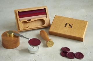 Wooden case from a sealing wax set that has engraved FS initials. sealing wax bars in red violet, red and pink, mini melting base and medallions 
