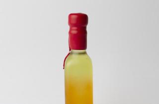 Small bottle in shades of orange and yellow, sealed with dripping red sealing wax