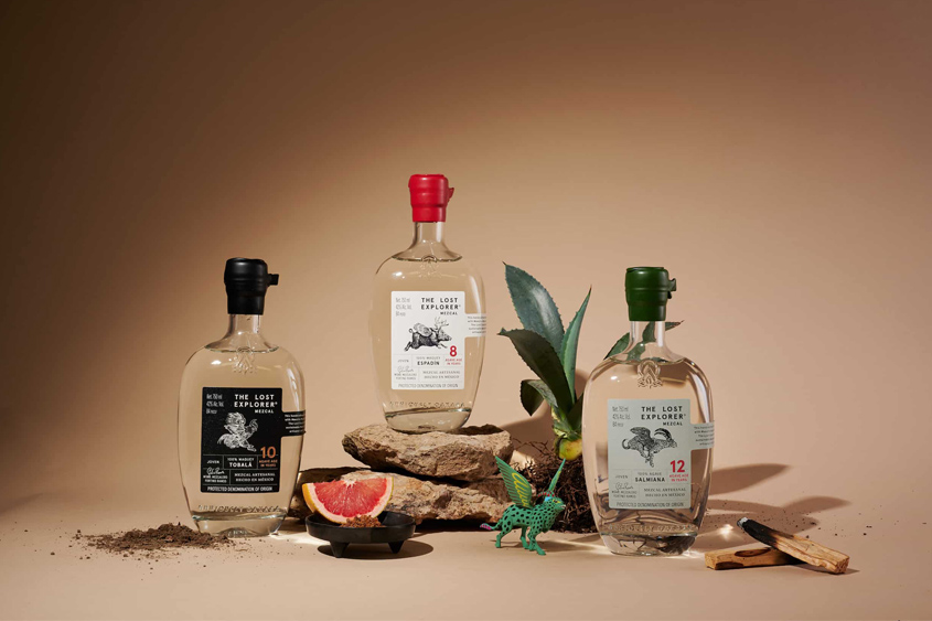 The Lost Explorer Mezcal bottles with black, red and green sealing wax in the neck of the bottle